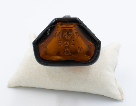 Underneath of poison bottle showing manufacturer marks.