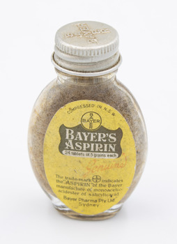 Front of medicine bottle showing 'Bayer's Aspirin' and other information on a label with yellow background