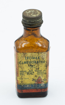 Front of medicine bottle upright with label visible.