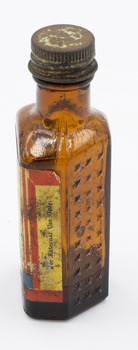 Side view of medicine bottle with cautionary label visible.