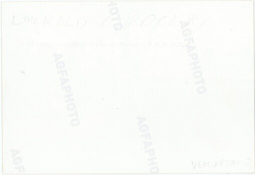The reverse of a printed photograph, featuring handwritten text in pencil.