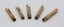 Five wooden clothes pegs lying flat with their heads in foreground