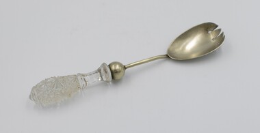 Silver plate salad serving fork with cut glass handle.