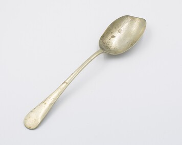 Serving spoon placed flat in supine position.