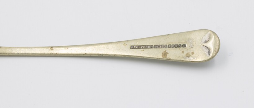 Underside of handle of spoon showing manufacturer marks