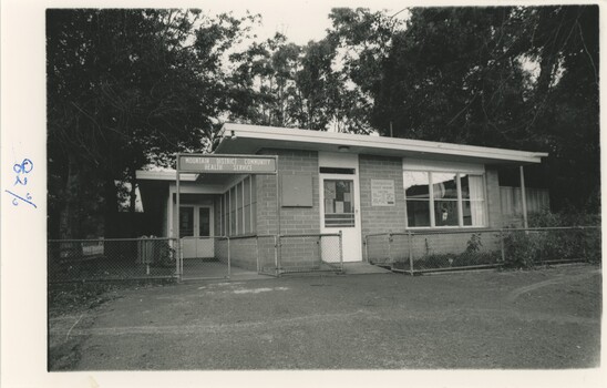 A black and white photograph of a brick building.