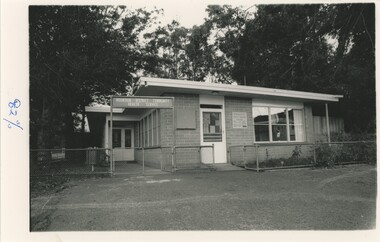 A black and white photograph of a brick building.