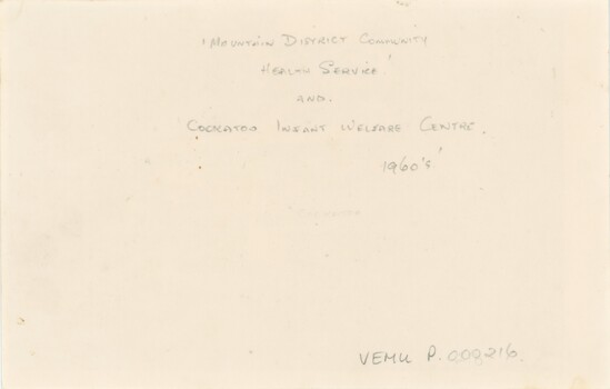 Reverse of a photograph with handwritten pencil text.