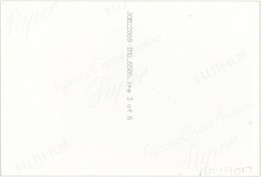 The reverse of a printed photograph, containing an accession number, printer paper logos, and printed technical information.