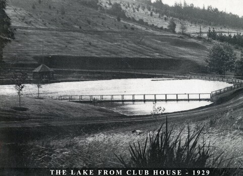 The lake of the Emerald Country Club looking towards the pavillion and Lakeside Drive just behind the lake .
