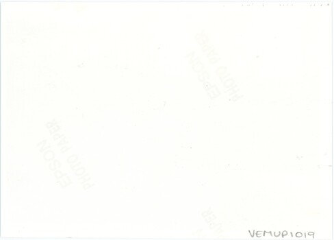 The reverse of a modern printed photograph, with photo paper logos and a handwritten accession number but not other annotation.