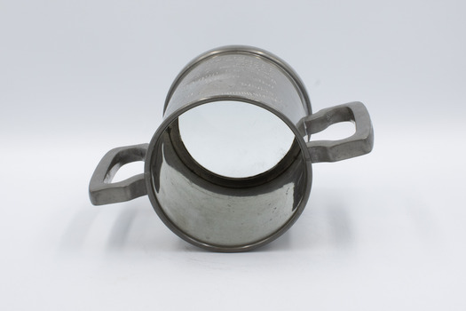 Trophy mug lying on side with rim in foreground.