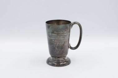 Front of upright cup with inscription visible