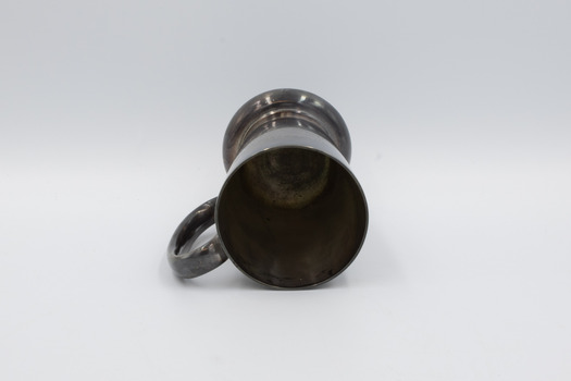 Award cup lying on side with rim in foreground.