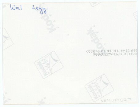 The reverse of a printed photograph, with handwritten annotation in pen, an accession number in pencil, and printed Kodak logos.