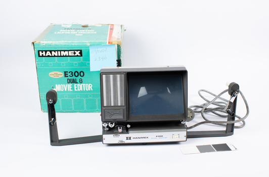 Movie editor with Hanimex box in the background