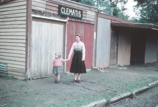 A woman and a young girl standing on the Clematis railway station platform.