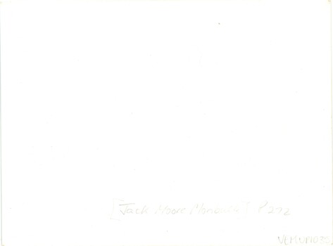 The white backing of a photograph with minimal handwritten annotation and an accession number.