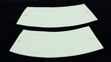 One side of two nurse cuffs showing holes for links