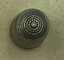 Top view of silver thimble showing spiral honeycomb pattern.