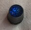Blue glass top of silver thimble.