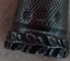 Rim of decorative silver thimble with manufacturers imprint visible on the lower part of the side.