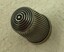 Silver thimble with spiral pattern on the top.