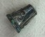 Silver thimble with scroll decoration on the side and abalone inset on band on rim. Seam on side visible.