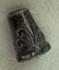 Closer view of thimble featuring scroll design on the side and abalone inset on band on rim.