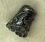 Ornate silver thimble showing decorative applied scrollwork.