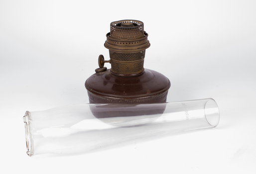 Aladdin lamp base with glass chimney separate in foreground