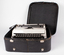 Typewriter inside case with lid of case opened