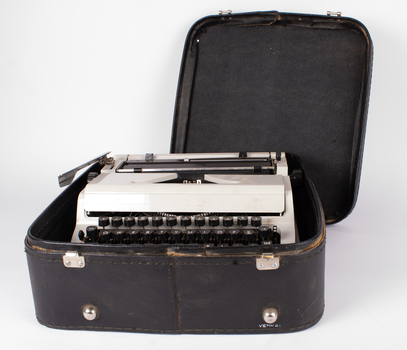 Typewriter inside case with lid of case opened