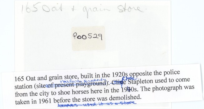 The reverse of a printed photograph with handwritten pencil and typed annotations.