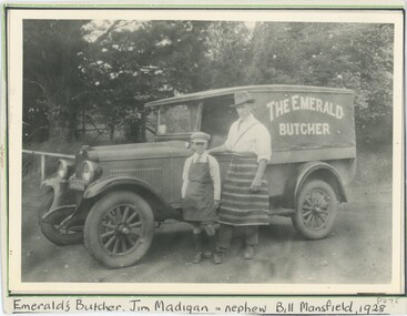 A black and white photograph of a man and a boy standing beside a truck; a handwritten annotation is below the photograph.