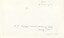 The reverse of a printed photograph with handwritten annotation in blue pen.
