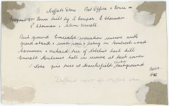 The card backing of a photograph with handwritten annotation with black pen.