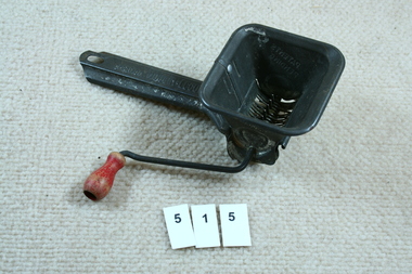 Vegetable mincer with wooden handle.