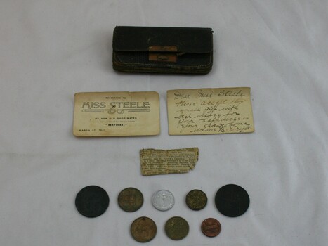 Purse and contents which include coins, cards and newspaper clipping