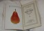 Inside front cover of sales catalogue with illustration of pear on left side and book details on right side.