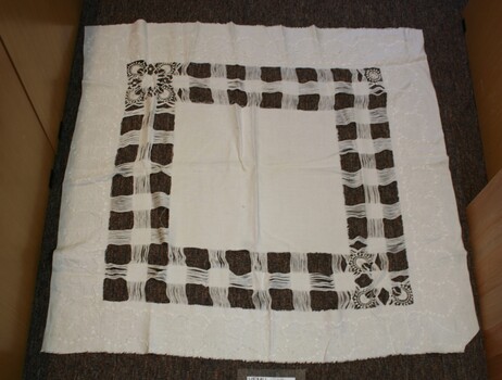 Table cloth with square check pattern.