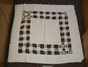 Table cloth with square check pattern.