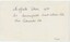The reverse of a printed photograph, featuring handwritten pen annotation and an accession number.