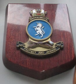 Badge - HMAS Warrnambool Ships Badge mounted on dark wood shield