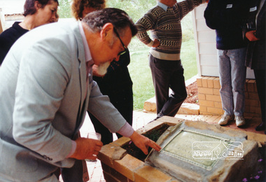Photograph, Jock Kyme checks the plaque, 10/10/1994