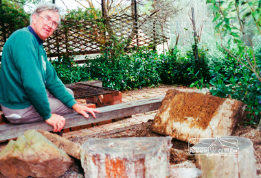 Photograph, Harry Gilham and the 1857 house well near the BBQ seating, 10 Oct 1994, 10/10/1994