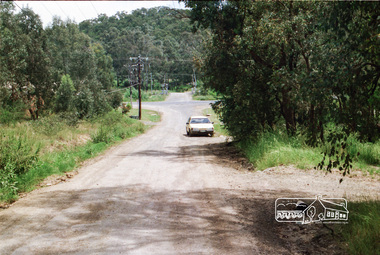 Photograph, Looking west along Mannish Road to the Heidelberg-Kinglake Road and beyond to the railway crossing on Wilson Road, Wattle Glen, c.1989, 1989c
