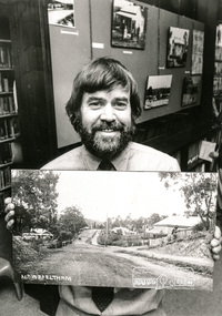 Photograph, Shire of Eltham Historical Society Secretary, Russell Yeoman, c.1988, holding an old photograph of Main Road, Eltham, 1988c