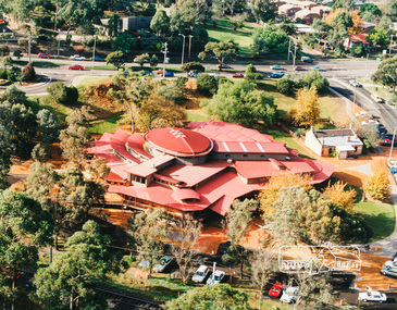 Photo album, Aerial view showing the new Eltham Library and relocated Shillinglaw Cottage, 1994