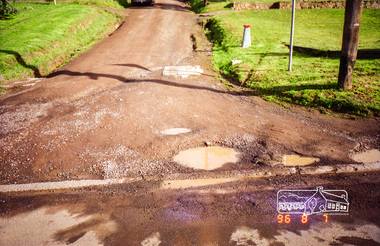 Photograph, Road surface conditions around Eltham: Looking west along John Street at the intersection with Bible Street, 7 Aug 1996, 1996